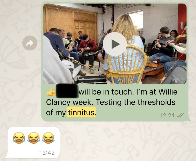 WhatsApp message saying “I’m at Willie Clancy week. Testing the limits of my tinnitus” with a video of a traditional Irish music session with multiple uileann pipers and fiddles.